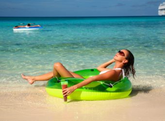 woman enjoying herself on a tropical beach in the bahamas